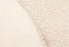 A close-up view of two different textured fabrics, one smooth and light-colored, the other a textured boucle in a similar light shade. Produktbild-Vorschau