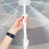 A hand is shown adjusting a mechanism on the pole of an open umbrella. Náhled obrázku produktu
