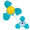 Two teal spinners with a yellow center on a white background. One spinner has a cartoon bear attached. Podgląd zdjęcia produktu