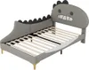 A children's bed with a dinosaur-shaped headboard, shown from a side angle against a white background. Produktbild-Vorschau