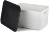 A white storage box with a black lid is shown against a white background. Produktbild-Vorschau