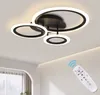 A modern ceiling lamp with multiple rings and a remote control.