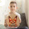 A young boy is holding a round clock with a watercolor fox painting on it. Produktbild-Vorschau