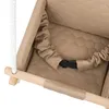 Close-up view of a beige baby swing seat with a safety strap and wooden bar. Produktbild-Vorschau