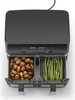 A top-down view of a dual-basket air fryer with potatoes in one basket and asparagus in the other. Produktbild-Vorschau