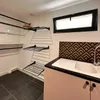 A laundry room with a sink, drying racks, and shelves. Produktbild-Vorschau