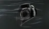 A black motorcycle helmet is shown in motion against a dark background with motion blur lines. Voir les images du produit