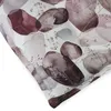 A close-up view of a fabric with a watercolor-style print of stones and delicate plants. Produktbild-Vorschau