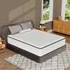 A mattress is displayed on a bed frame in a bedroom setting, with a nightstand and dresser visible. Produktbild-Vorschau
