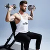 A man is sitting on a weight bench and lifting dumbbells. Produktbild-Vorschau