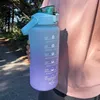 A person holding a large, gradient-colored water bottle outdoors. Produktbild-Vorschau