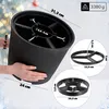 A person is holding a Christmas tree stand, with close-up diagrams of its components and dimensions shown. Voir les images du produit