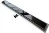 A linear shower drain with a black glass insert and a silver metal outlet pipe, shown from a diagonal angle against a white background. Produktbild-Vorschau