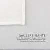 A close-up of a white blanket with text overlay describing its features. Produktbild-Vorschau