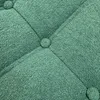 A close-up view of tufted green upholstery. Voir les images du produit