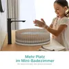A young girl is washing her hands at a modern sink with a transparent basin and a black faucet. Produktbild-Vorschau