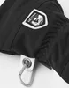 Close-up of a black glove with a HESTRA logo patch and a carabiner clip. Náhľad obrázku produktu