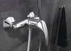 A close-up shot of a chrome shower faucet mounted on a dark gray tiled wall. Náhled obrázku produktu