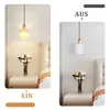 A split image showing a pendant lamp in two states: on and off, in a bedroom setting. Produktbild-Vorschau