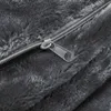 A close-up view of a zipper on a gray furry fabric. Produktbild-Vorschau
