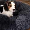 A beagle puppy is resting in a dark gray, plush dog bed. Anteprima dell’immagine prodotto