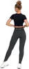 A woman wearing black crop top and grey leggings, shown from the back. Produktbild-Vorschau