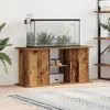 An aquarium with fish on top of a wooden cabinet. Produktbild-Vorschau