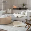 A living room scene with a sofa, coffee table, and rug. Voir les images du produit