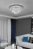 A modern living room with a white sofa, blue and black pillows, and a white marble coffee table. Produktbild-Vorschau