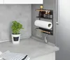 A kitchen counter with a magnetic shelf holding spices, paper towels, and a towel, next to a potted plant. Voir les images du produit