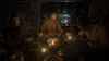 Three people are sitting around a table in a dimly lit room, appearing to be eating a meal. Produktbild-Vorschau