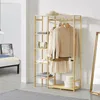 A bamboo garment rack with clothes and accessories in a room. Produktbild-Vorschau