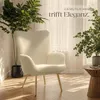 A cream-colored armchair is placed in a well-lit room with plants and sunlight streaming through sheer curtains. Náhled obrázku produktu