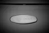 A close-up of a logo on a dark surface. Produktbild-Vorschau