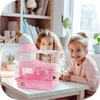 Two young girls are smiling and looking at the camera, with a pink hamster cage in the foreground. Náhľad obrázku produktu