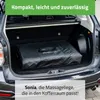 A black massage table in a bag is placed in the trunk of a car. Produktbild-Vorschau