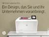 A white HP Color LaserJet Pro printer is shown on a white desk against a textured light brown wall. Podgląd zdjęcia produktu
