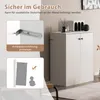 A white sideboard cabinet with two doors, shown in a room setting with decorative items on top. The image also includes inset graphics highlighting safety features. Podgląd zdjęcia produktu
