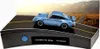 A blue Porsche 911 Turbo model car is displayed on a diorama of a road with a scenic mountain background. Produktbild-Vorschau