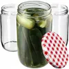Three glass jars, one filled with pickles, and a red and white checkered lid. Podgląd zdjęcia produktu