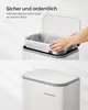A person's hands are shown placing a liner into a white trash can with a gray rim. The lid of the trash can is open. Below this, a closed trash can with the brand name 'SONGMICS' is visible. Produktbild-Vorschau