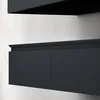 A close-up view of a dark gray bathroom vanity with a decorative trim above the drawers, mounted on a textured light gray wall. Anteprima dell’immagine prodotto