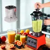 A blender is shown in use, with a hand operating the lid, surrounded by fresh fruits and juices. Produktbild-Vorschau
