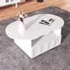 A white, cloud-shaped coffee table with a storage compartment sits on a gray rug. Voir les images du produit
