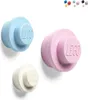 Three LEGO-style coat hooks in light blue, light pink, and white, mounted on a white background. Produktbild-Vorschau