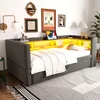 A corner daybed with built-in shelving and LED lighting, decorated with framed pictures and a lamp. Náhled obrázku produktu