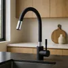 A modern black kitchen faucet with a flexible spout is shown in a kitchen setting. Náhľad obrázku produktu