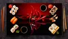 A top-down view of a black serving platter with sushi, chili peppers, and soy sauce. Náhled obrázku produktu