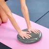 A person's hands are resting on a balance pad on a yoga mat. Náhled obrázku produktu