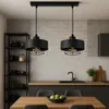 A modern kitchen with a dining table and pendant lights. Náhled obrázku produktu